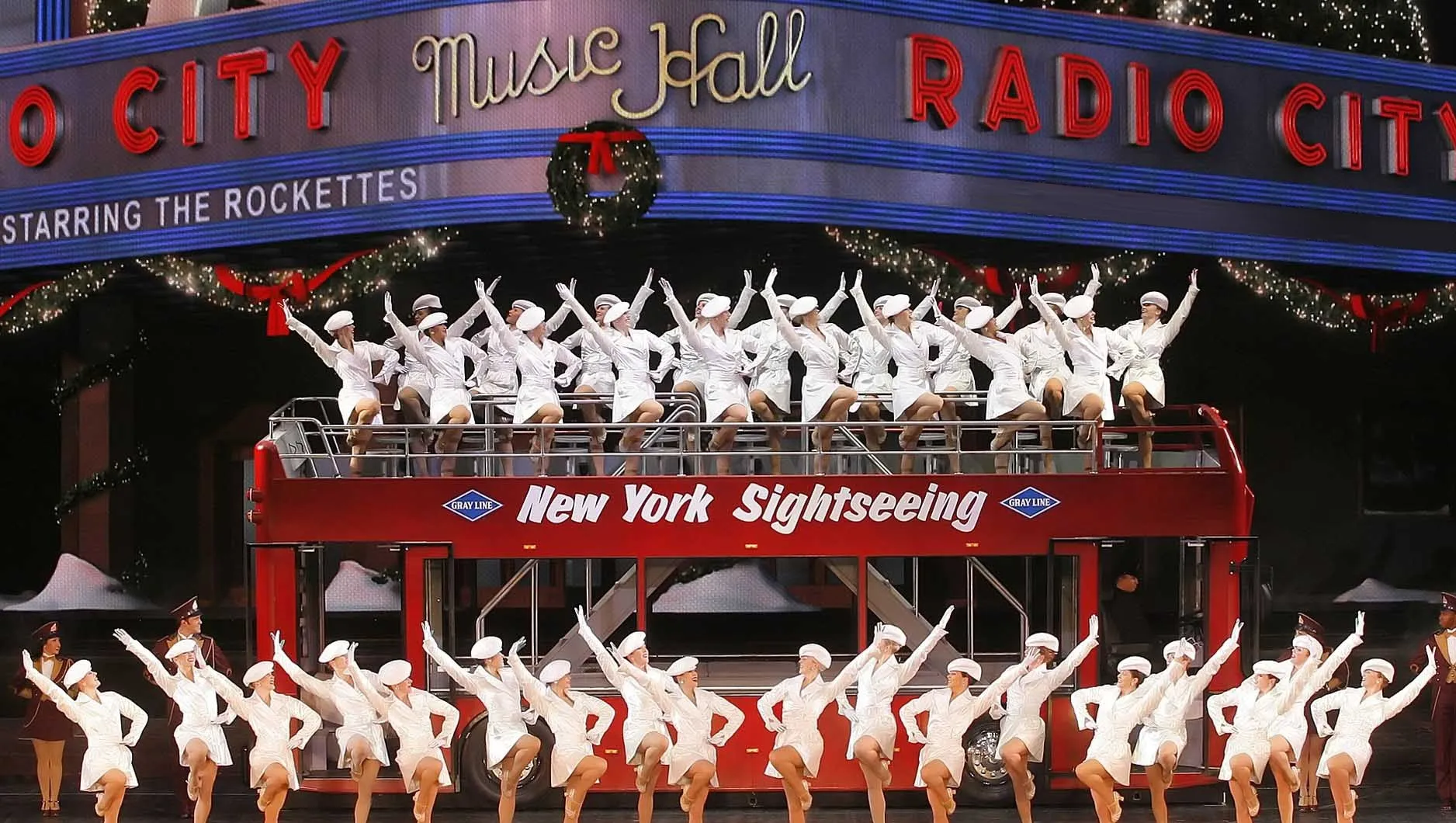 A group of dancers in white hats and costumes.